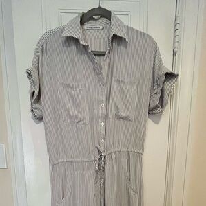 Grey pinstriped jumpsuit with cuffed sleeves and pockets